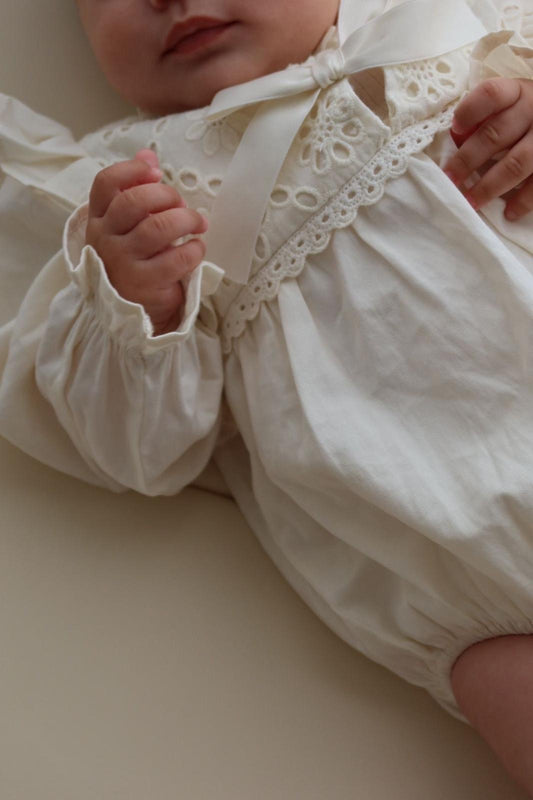 Festive white bow tie muslin bodysuit